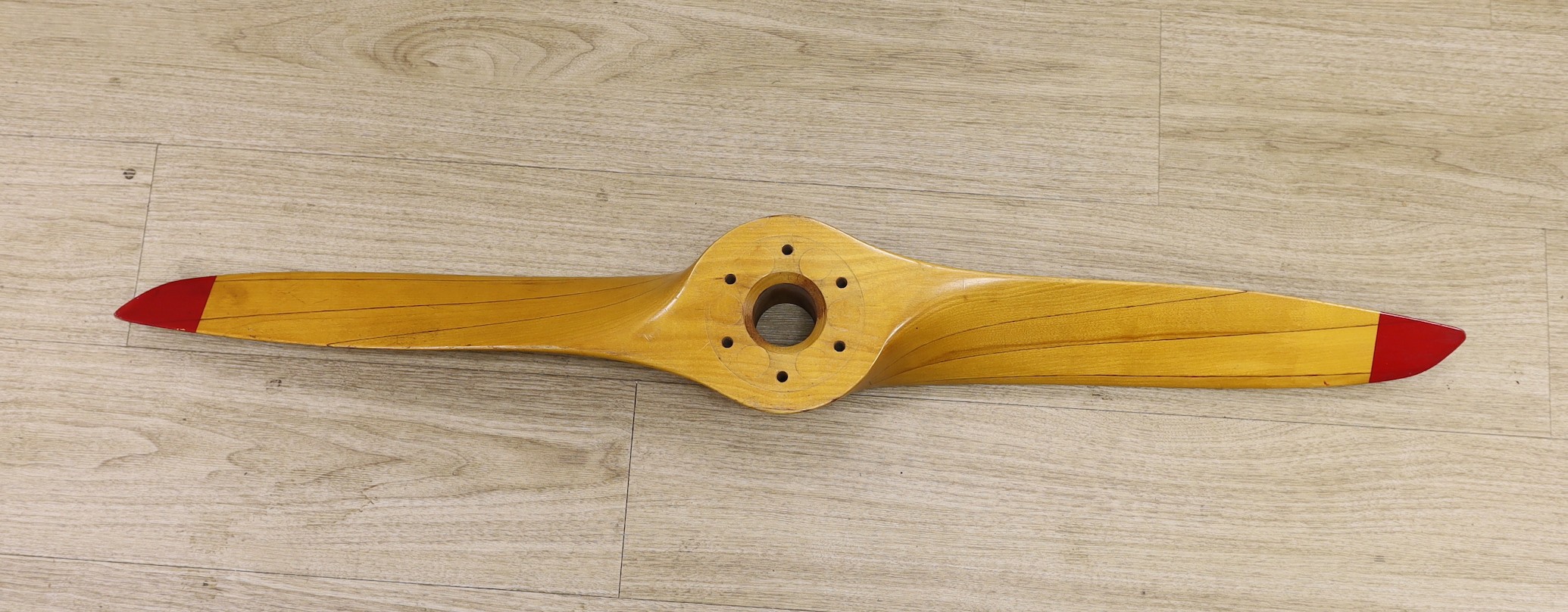 A Sensenich Corp laminated wooden propellor with red painted tips, P/N-22048, model no-276-17 serial no.-17991, 112cms long